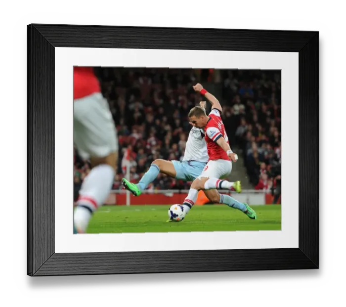 Framed Print : Lukas Podolski scores his and Arsenals 1st goal under pressure from Winston Reid (West Ham) Framed Print : Lukas Podolski scores his and Arsenals 1st goal under pressure from Winston Reid (West Ham)