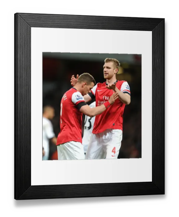 Framed Print : Podolski and Mertesacker: Arsenal's Unstoppable Duo Celebrates First Goal in 3:1 Victory over West Ham