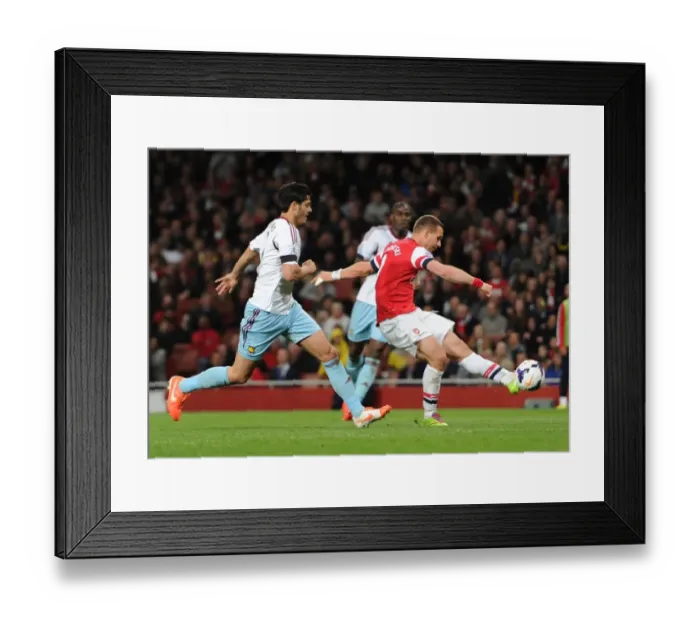 Framed Print : Lukas Podolski scores his 2nd and Arsenals 3rd goal under pressure from James Tomkins (West Ham) Framed Print : Lukas Podolski scores his 2nd and Arsenals 3rd goal under pressure from James Tomkins (West Ham)