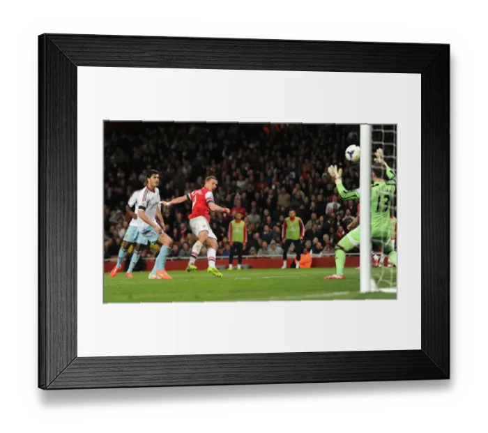 Framed Print : Lukas Podolski Scores Dramatic Goal Past James Tomkins and Adrian in Arsenal's Victory over West Ham United Framed Print : Lukas Podolski Scores Dramatic Goal Past James Tomkins and Adrian in Arsenal's Victory over West Ham United