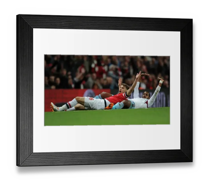 Framed Print : Arsenal's Aaron Ramsey Clashes with West Ham's Ricardo Vaz Te in Intense Premier League Match