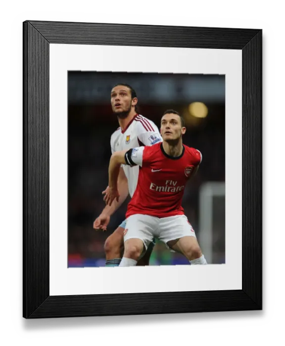 Framed Print : Arsenal's Thomas Vermaelen Holds Off Andy Carroll in Intense Arsenal v West Ham United Clash