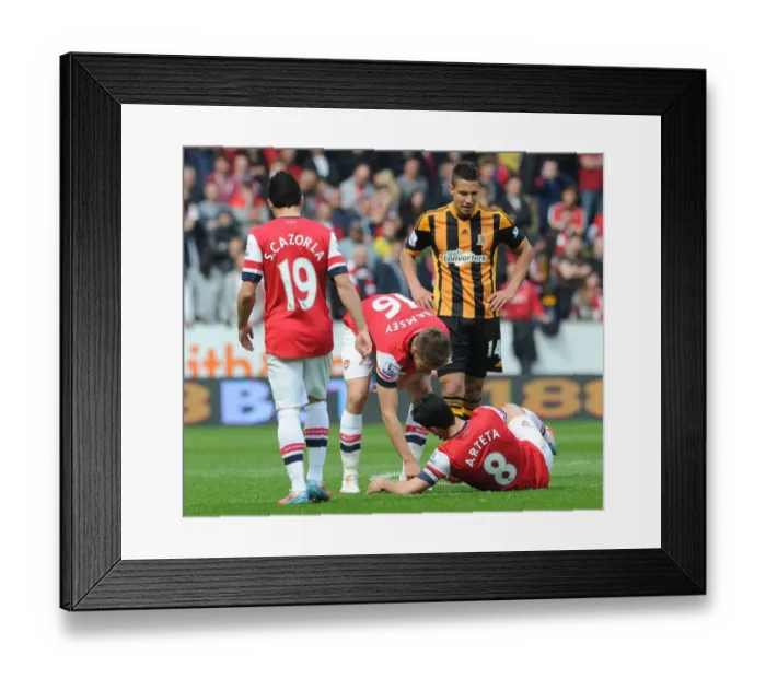 Framed Print : Mikel Arteta and Aaron Ramsey: Unusual Teamwork - Tooth Search on the Field (Hull City vs Arsenal, 2014)
