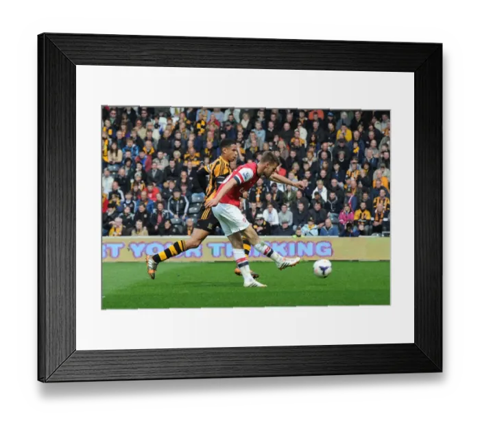 Framed Print : Aaron Ramsey Scores Under Pressure Against Curtis Davies: Hull City vs Arsenal (2014) Framed Print : Aaron Ramsey Scores Under Pressure Against Curtis Davies: Hull City vs Arsenal (2014)