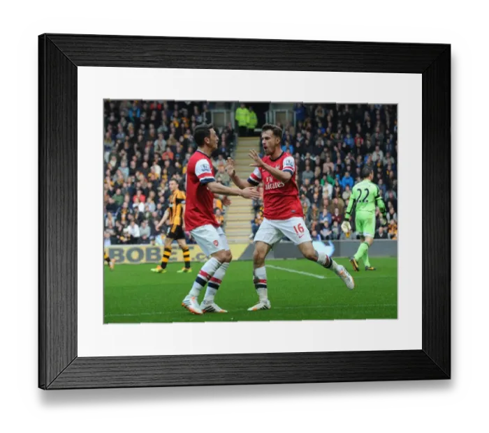 Framed Print : Arsenal Stars: Ramsey and Ozil Celebrate Goal in Hull City Victory, Premier League 2013-14