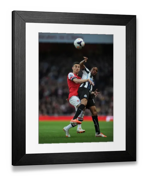 Framed Print : Arsenal vs Newcastle United: Koscielny vs Remy in Intense Battle