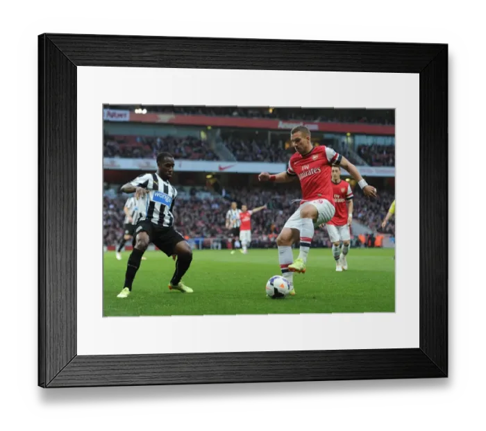 Framed Print : Lukas Podolski (Arsenal) Vurnon Anita (Newcastle). Arsenal 2: 0 Newcastle United Framed Print : Lukas Podolski (Arsenal) Vurnon Anita (Newcastle). Arsenal 2: 0 Newcastle United