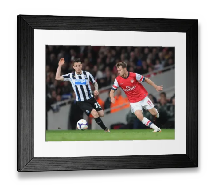 Framed Print : Aaron Ramsey (Arsenal) Mathieu Debuchy (Newcastle). Arsenal 2: 0 Newcastle United Framed Print : Aaron Ramsey (Arsenal) Mathieu Debuchy (Newcastle). Arsenal 2: 0 Newcastle United