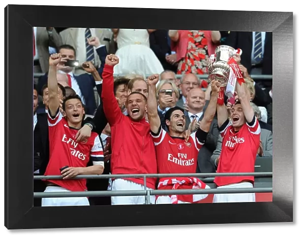 Arsenal Celebrates FA Cup Victory: Ozil, Podolski, Arteta, and Vermaelen Lift the Trophy