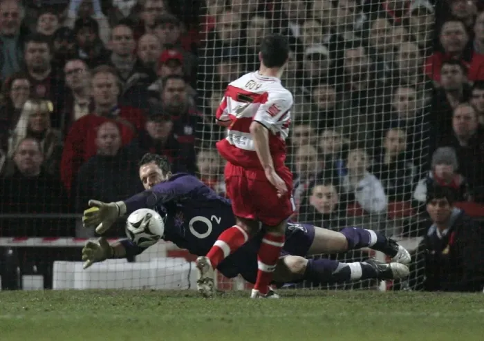 Framed Print : I. Manuel Almunia (Arsenal) saves at the feet of Lewis Guy (Doncaster)