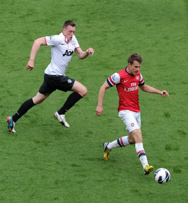 Framed Print : Aaron Ramsey (Arsenal) Phil Jones (Man Utd). Arsenal 1: 1 Manchester United. Barclays Premier League Framed Print : Aaron Ramsey (Arsenal) Phil Jones (Man Utd). Arsenal 1: 1 Manchester United. Barclays Premier League