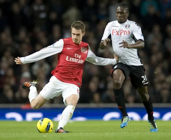 Framed Print : Aaron Ramsey of Arsenal takes on Dickson Etuhu of Fulham during the Barclays Premier League match between Arsenal and Fulham at Emirates Stadium on November 26, 2011 in London, England. Credit; Arsenal
