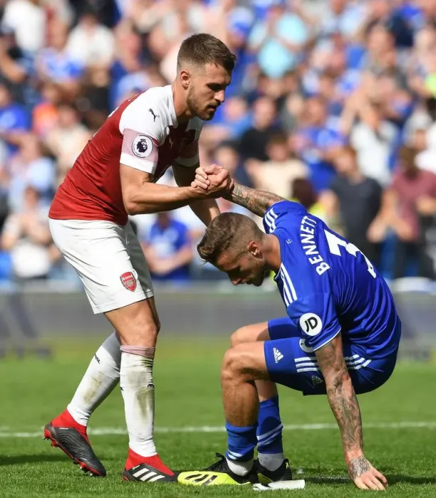 Framed Print : Aaron Ramsey Consoles Joe Bennett after Intense Cardiff vs. Arsenal Clash
