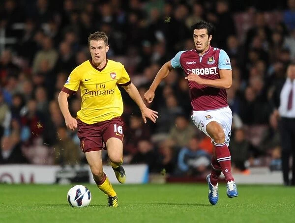Aaron Ramsey Outmaneuvers James Tomkins: A Pivotal Moment in the West Ham United vs. Arsenal Premier League Clash (2012-13)