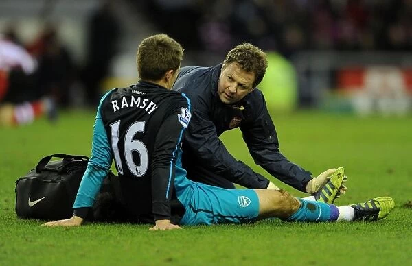 Aaron Ramsey Receives Treatment from Physio Colin Lewin during Sunderland vs Arsenal FA Cup Match