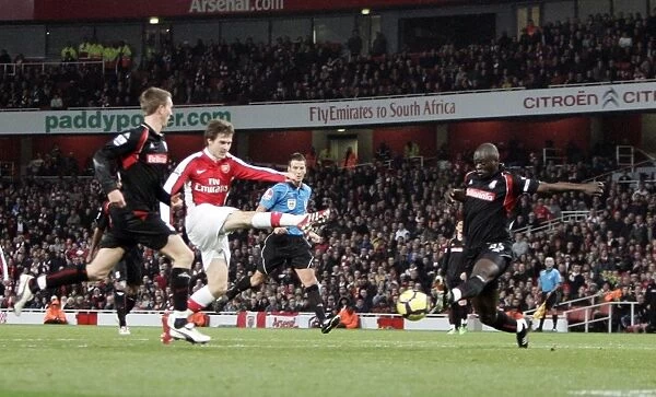 Aaron Ramsey Scores Arsenal's Second Goal Against Stoke City Amidst Pressure from Abdoulaye Faye and Danny Collins