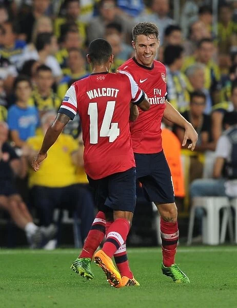 Aaron Ramsey and Theo Walcott Celebrate Goals: Arsenal's Dominance over Fenerbahce in 2013-14 UEFA Champions League Play-offs