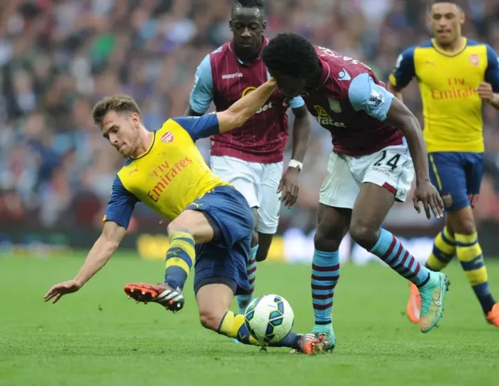 Framed Print : Aaron Ramsey vs. Carlos Sanchez: Intense Battle in Aston Villa vs. Arsenal Premier League Clash