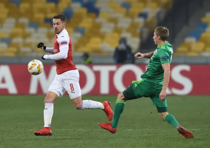 Framed Print : Aaron Ramsey vs. Igor Perduta: Intense Clash in Arsenal's UEFA Europa League Match against Vorskla Poltava Framed Print : Aaron Ramsey vs. Igor Perduta: Intense Clash in Arsenal's UEFA Europa League Match against Vorskla Poltava