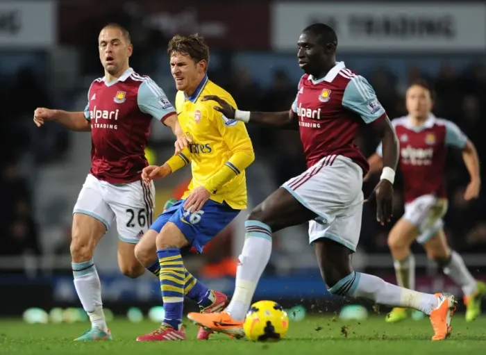 Framed Print : Aaron Ramsey's Injury Drama: Joe Cole and Mohamed Diame Challenge the Arsenal Star in West Ham vs Arsenal (2013-14)