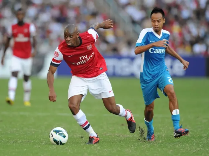 Framed Print : Abou Diaby Outmaneuvers Cheng Siu Wai: Kitchee FC vs. Arsenal FC, 2012
