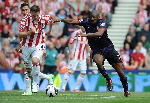 Abou Diaby Outmaneuvers Robert Huth: A Battle in the Premier League Match Between Stoke City and Arsenal (2012-13)