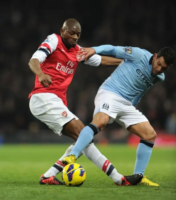 Framed Print : Abou Diaby vs. Carlos Tevez: Intense Tackle in Arsenal vs. Manchester City Premier League Clash (2012-13)