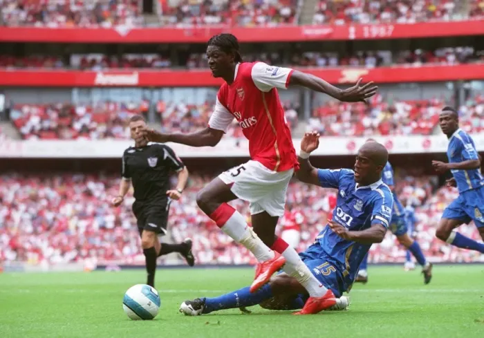 Framed Print : Adebayor's Brace: Arsenal Overpowers Distin and Portsmouth 3-1 in Premier League