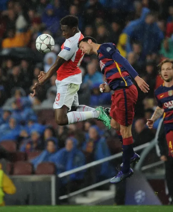 Framed Print : Aerial Showdown: Danny Welbeck vs. Sergio Busquets in the UEFA Champions League Battle between Arsenal and Barcelona