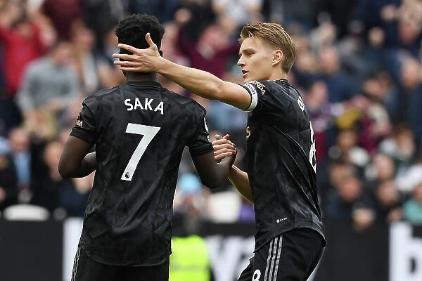 Agonizing Moment: Odegaard Consoles Saka After Missed Penalty in West Ham vs. Arsenal Clash