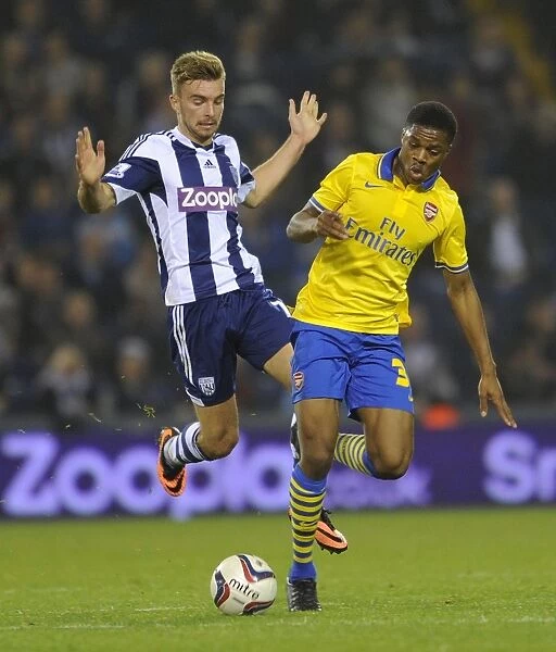 Akpom vs. Morrison: A Battle in the Capital One Cup - Arsenal's Akpom Clashes with West Bromwich Albion's Morrison (September 2013)
