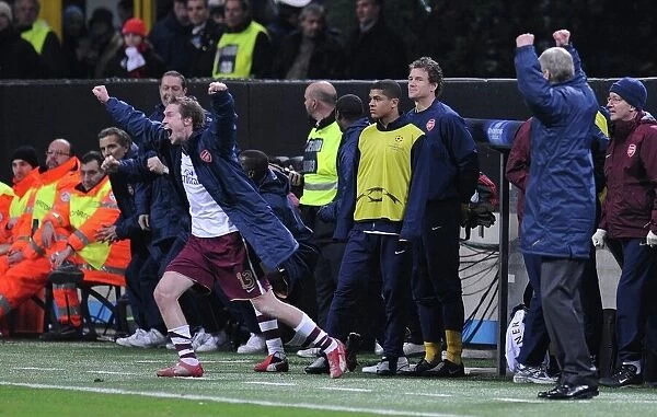 Alex Hleb and the Arsenal bench celebrate at the final whistle