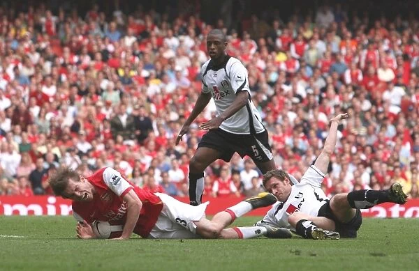 Alex Hleb is brought down for a penalty by Fulham defender Moritz Volz