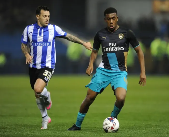 Framed Print : Alex Iwobi vs. Ross Wallace: A Fierce Face-Off in the Capital One Cup Clash Between Arsenal and Sheffield Wednesday