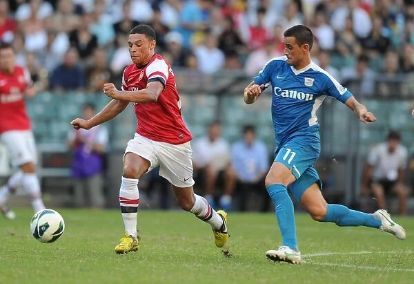 Alex Oxlade-Chamberlain Outmaneuvers Yago Lopez in Arsenal's Win Against Kitchee FC (2012)