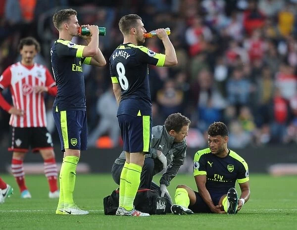 Alex Oxlade-Chamberlain Receives Treatment from Arsenal Physio Colin Lewin during Southampton vs Arsenal Match, 2017