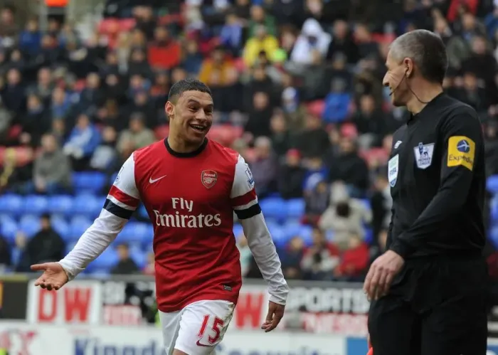 Framed Print : Alex Oxlade-Chamberlain's Light-Hearted Moment: A Humorous Break in the Intense Wigan Athletic vs Arsenal Clash (2012-13) - Arsenal's Star Player Jokes with the Referee's Assistant Framed Print : Alex Oxlade-Chamberlain's Light-Hearted Moment: A Humorous Break in the Intense Wigan Athletic vs Arsenal Clash (2012-13) - Arsenal's Star Player Jokes with the Referee's Assistant