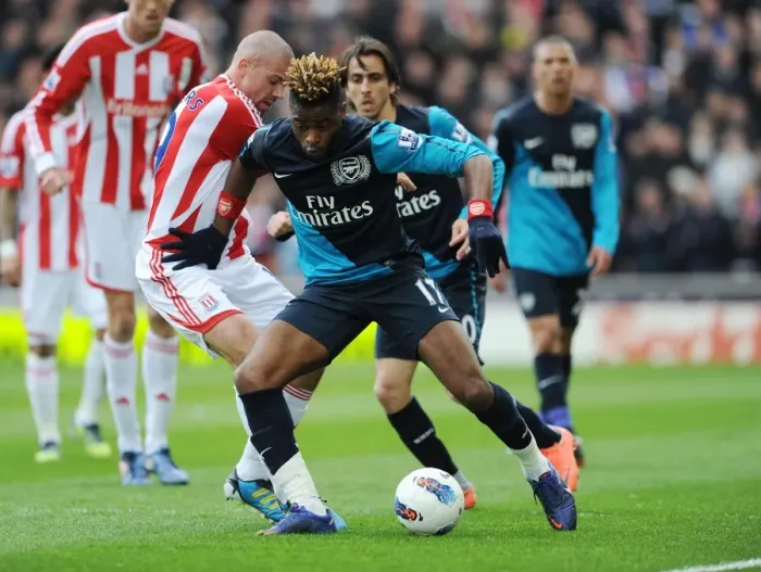 Framed Print : Alex Song Outmaneuvers Jonathan Walters: A Pivotal Moment in Stoke vs. Arsenal Premier League Clash