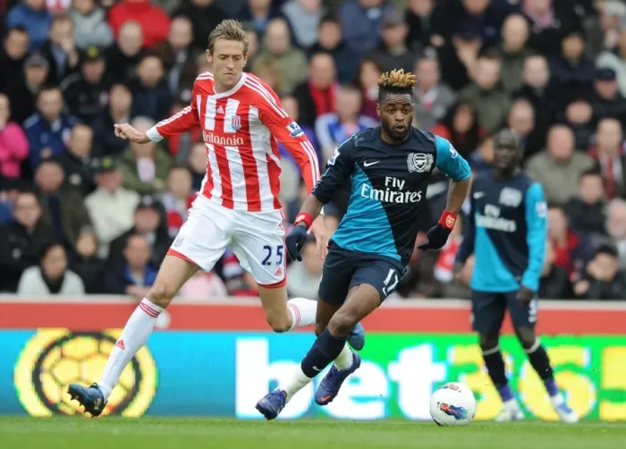 Framed Print : Alex Song Overpowers Peter Crouch: A Battle in the Premier League Clash Between Stoke and Arsenal Framed Print : Alex Song Overpowers Peter Crouch: A Battle in the Premier League Clash Between Stoke and Arsenal