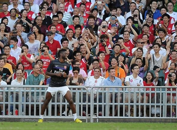 Alex Song Shares a Laugh with Arsenal Fans during Kitchee FC Match, 2012