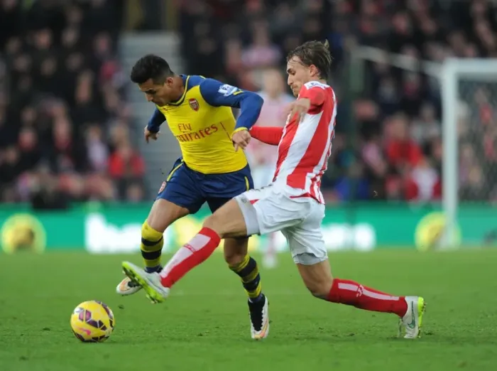 Framed Print : Alexis Sanchez Outmaneuvers Marc Muniesa: A Moment from the Stoke City vs. Arsenal Premier League Clash (2014-15)
