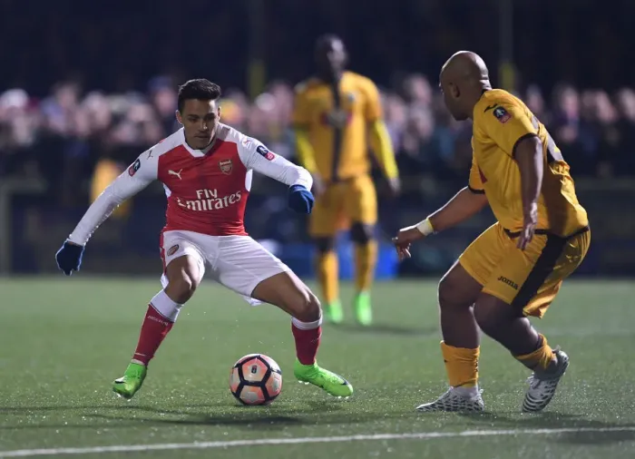 Framed Print : Alexis Sanchez vs. Simon Downer: A FA Cup Fifth Round Battle - Sutton United's Surprising Showdown with Arsenal Framed Print : Alexis Sanchez vs. Simon Downer: A FA Cup Fifth Round Battle - Sutton United's Surprising Showdown with Arsenal