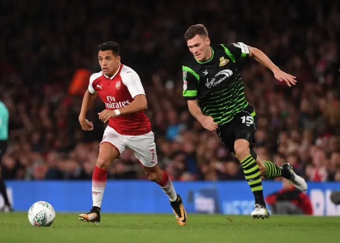 Framed Print : Alexis Sanchez vs. Joe Wright: Arsenal's Star Forward Clashes with Doncaster's Defender in Carabao Cup Showdown
