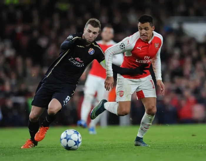Framed Print : Alexis Sanchez vs. Domagoj Antolic: A Battle in the Arsenal vs. Dinamo Zagreb UEFA Champions League Clash Framed Print : Alexis Sanchez vs. Domagoj Antolic: A Battle in the Arsenal vs. Dinamo Zagreb UEFA Champions League Clash