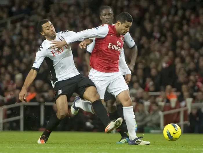Framed Print : Andre Santos of Arsenal takes on Mousa Dembele of Fulham during the Barclays Premier League match between Arsenal and Fulham at Emirates Stadium on November 26, 2011 in London, England. Credit; Arsenal