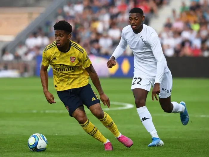 Framed Print : Angers vs Arsenal: Reiss Nelson Faces Off Against Jeff Reine-Adelaide in Pre-Season Friendly