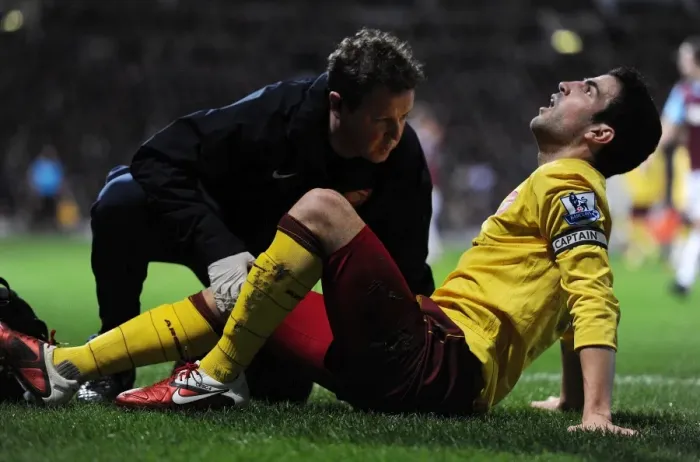 Framed Print : Arsenal captain Cesc Fabregas is treated by physio Colin Lewin. West Ham United 0 Framed Print : Arsenal captain Cesc Fabregas is treated by physio Colin Lewin. West Ham United 0