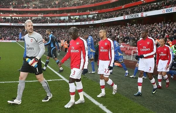 Arsenal captain Manuel Almunia leads out the team