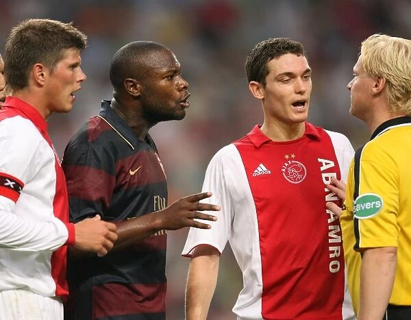 Arsenal captain William Gallas and Ajax defender Thomas Vermaelen talk to the referee