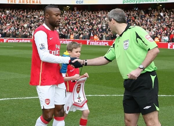 Arsenal captain William Gallas shakes hands with referee Martin Atkinson before the match